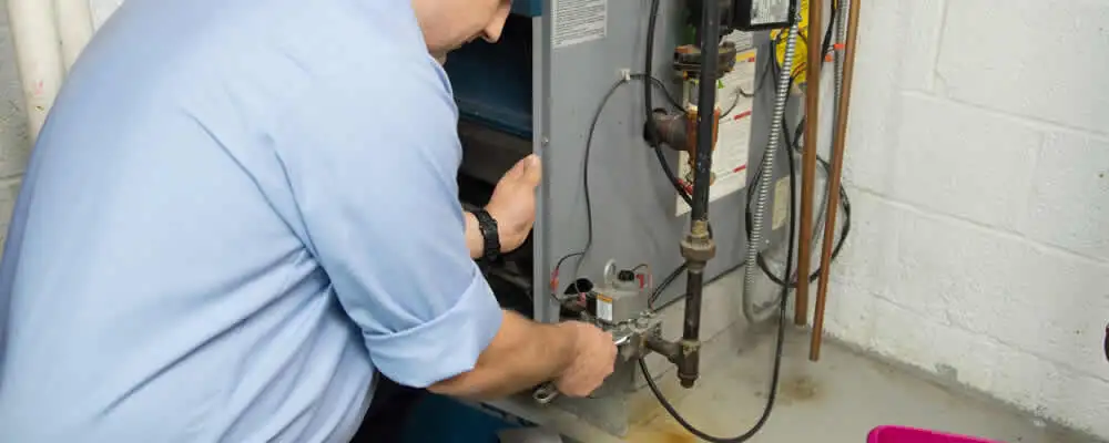 Furnace repair technician inspecting and servicing a home heating system in Bradenton, FL
