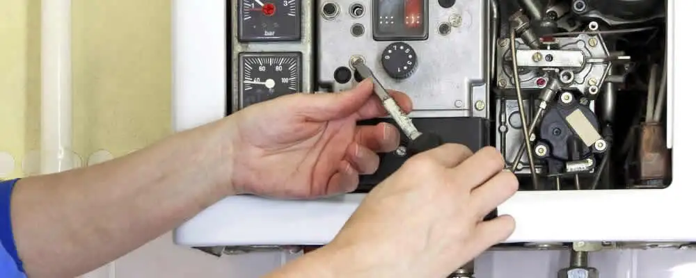 Heating repair technician adjusting boiler controls and components in Bradenton, FL