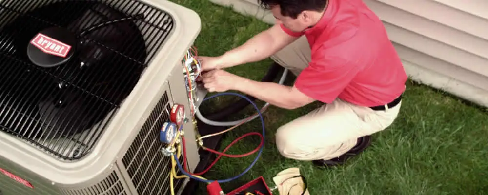 HVAC technician servicing an outdoor air conditioner unit in Bradenton, FL