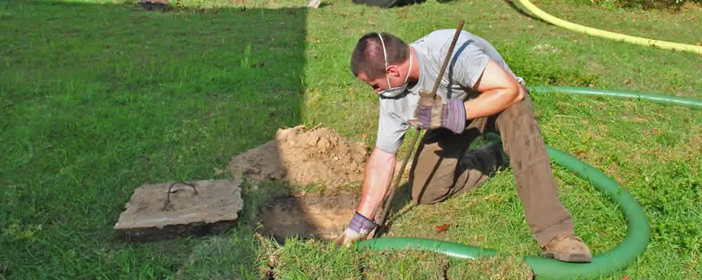 Septic pumping technician servicing a residential septic tank in Bradenton, FL